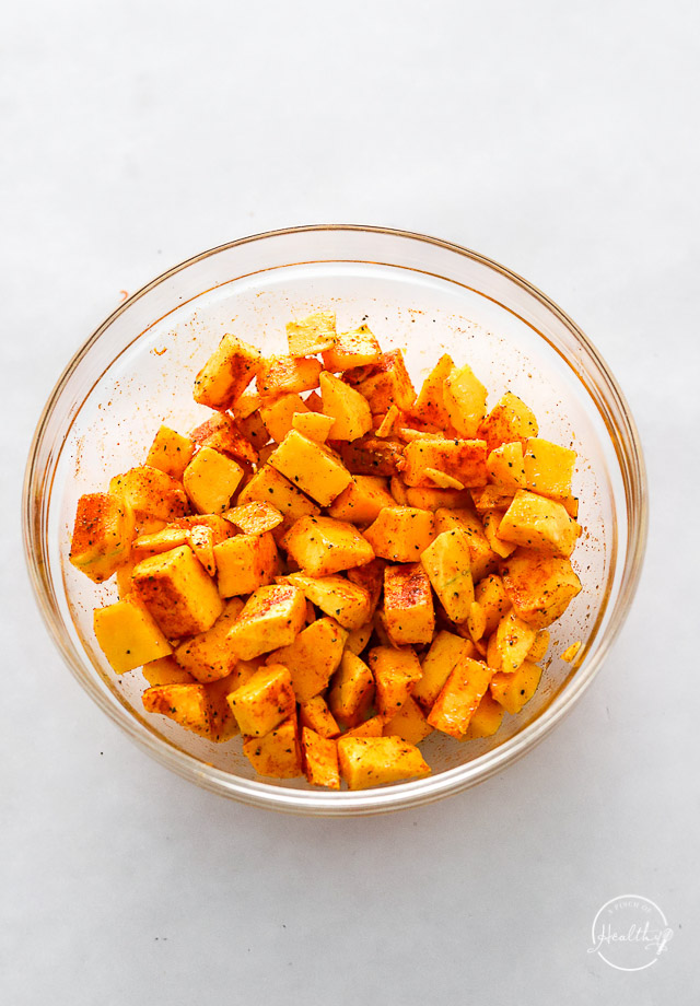 Uncooked veggies in bowl with seasoning