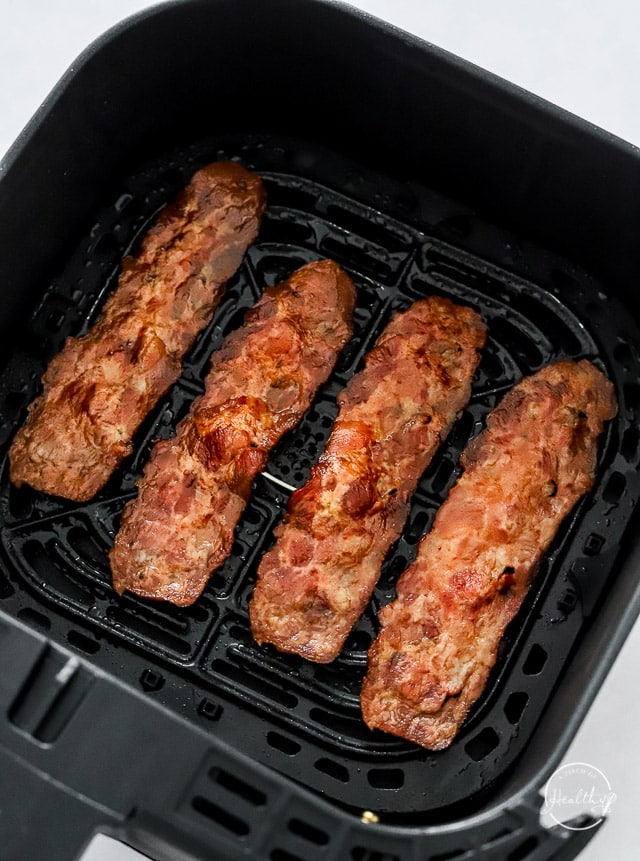 Cooked turkey bacon in air fryer basket