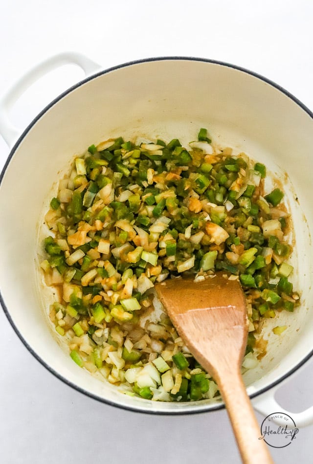 adding veggies to roux in a pot