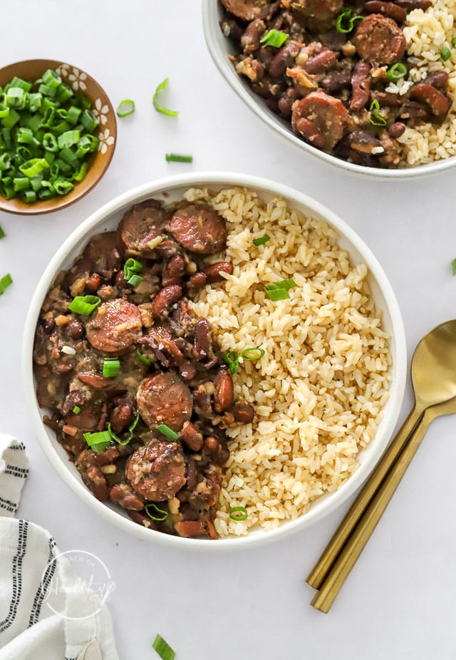Red beans and rice in a white bowl sprinkled with green onion
