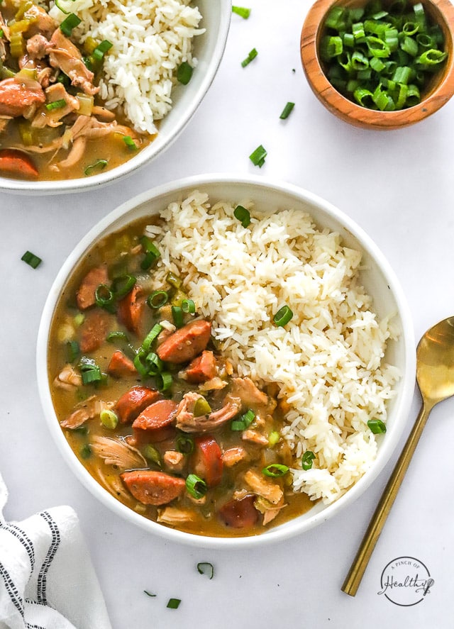 Chicken and sausage gumbo in two bowls overhead