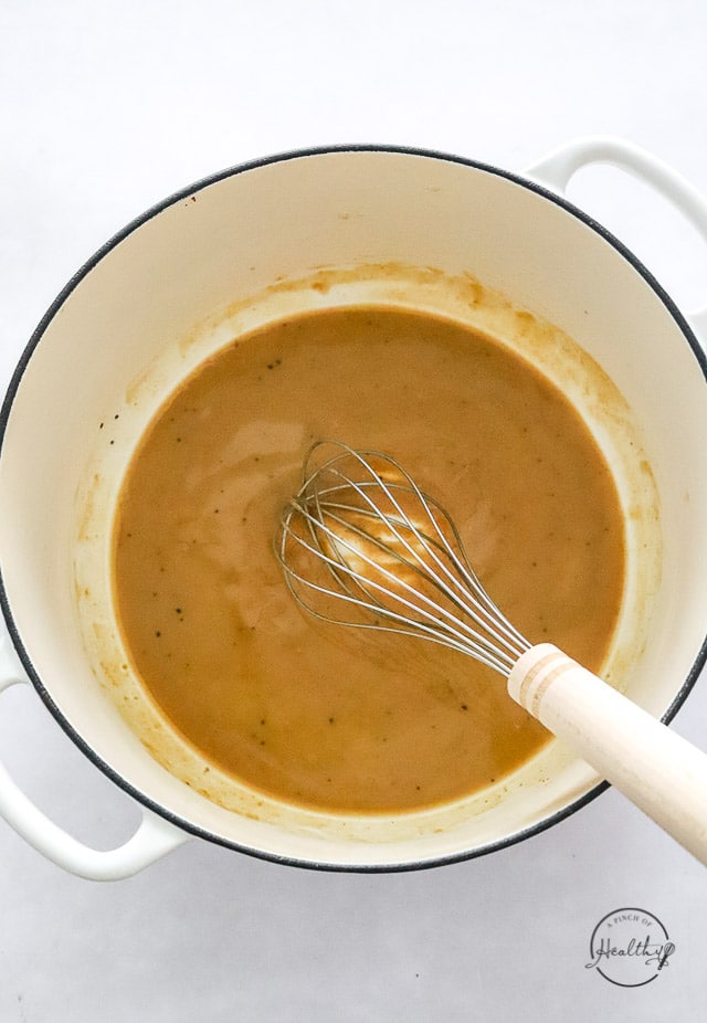 making roux in a pot with a whisk