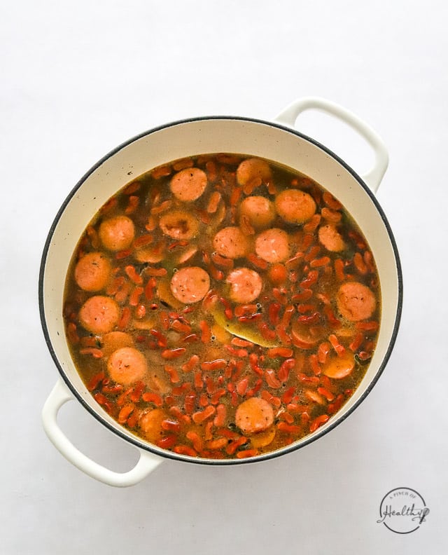 read beans and sausage ingredients in a pot prior to cooking
