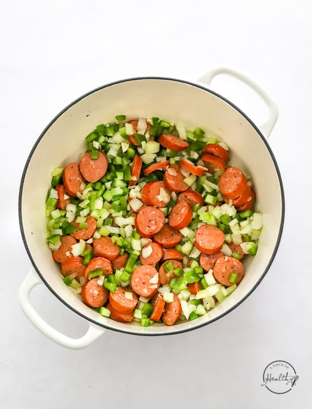 veggies and sausage cooking in a pot