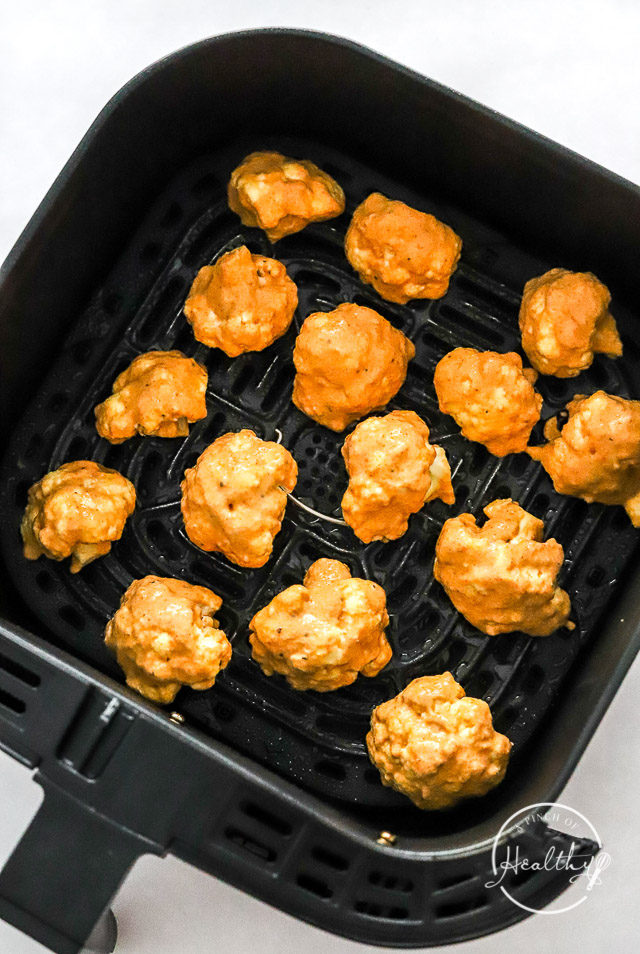 air fryer buffalo cauliflower in fryer basket prior to cooking