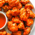 air fryer buffalo cauliflower with extra sauce on the side