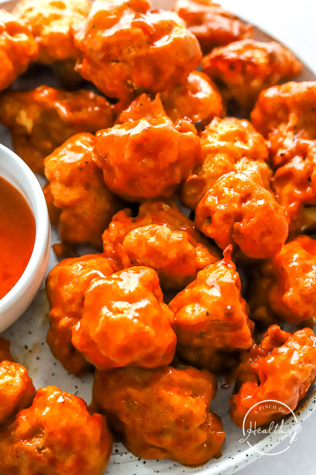 air fryer buffalo cauliflower with extra sauce on the side