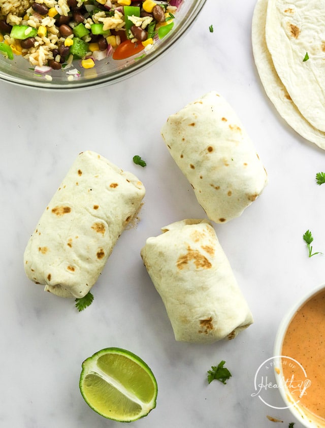 rolled up bean burritos on white surface