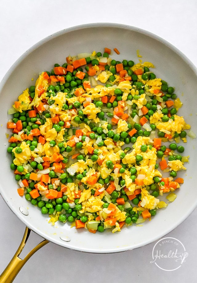 cooked eggs and veggies in a pan