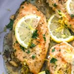 lemon chicken in a pan closeup with lemon slices on top