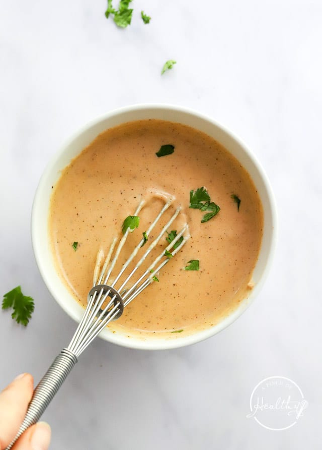 whisking homemade sauce in a bowl
