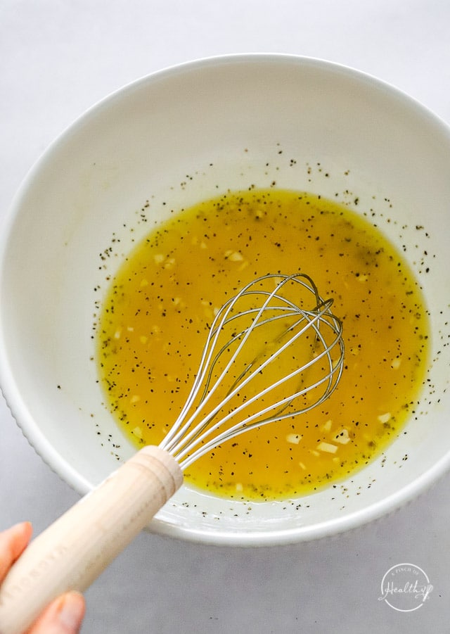 whisking dressing in a bowl