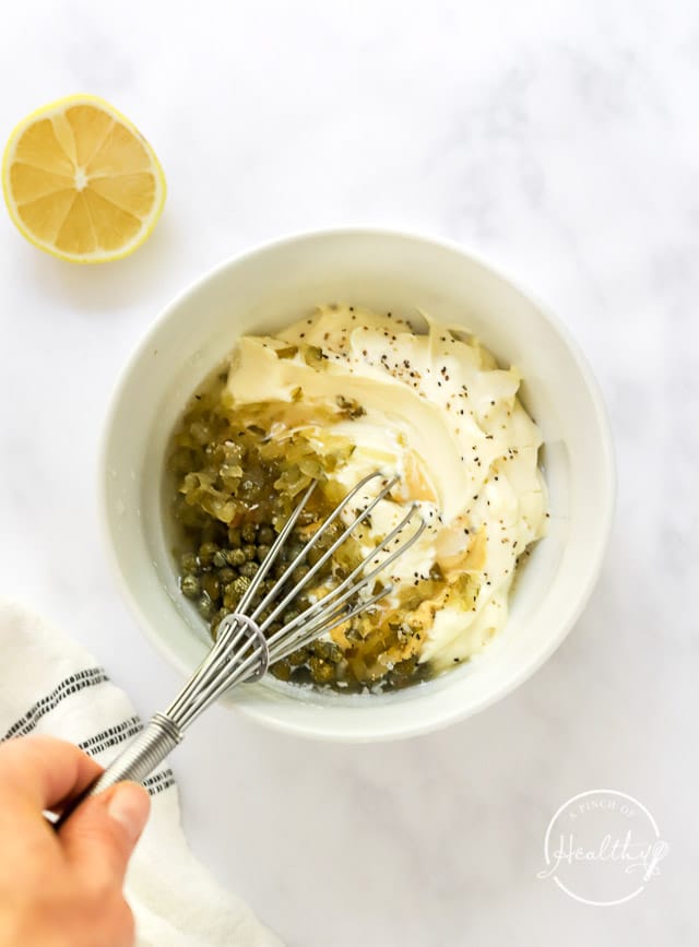 whisking together homemade tartar sauce recipe in a bowl