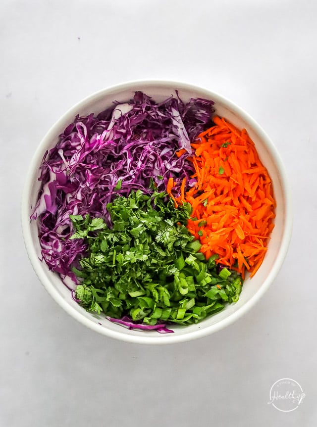 slaw ingredients in a bowl prior to mixing