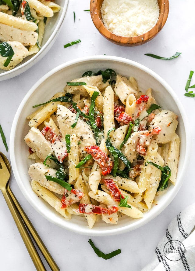 Creamy Tuscan Chicken Pasta in a white bowl