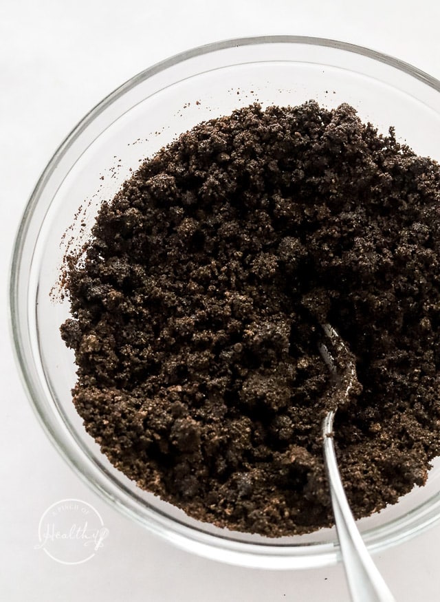 crushed Oreos mixed with melted butter in a bowl