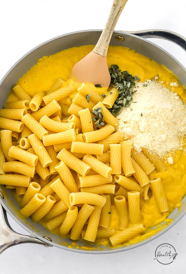 assembling butternut squash pasta in a pan