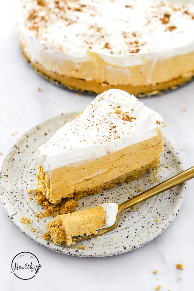 slice of no bake pumpkin cheesecake on a plate with fork