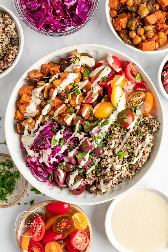 Mediterranean Bowls surround by individual ingredients in smaller bowls
