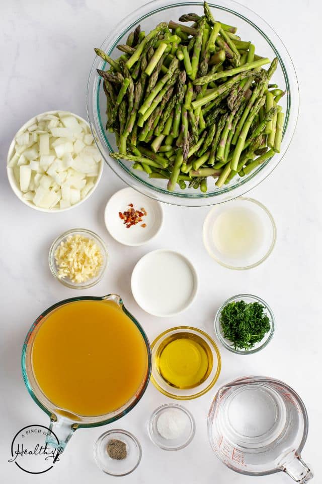 Ingredients for asparagus soup shot from overhead in separate small dishes