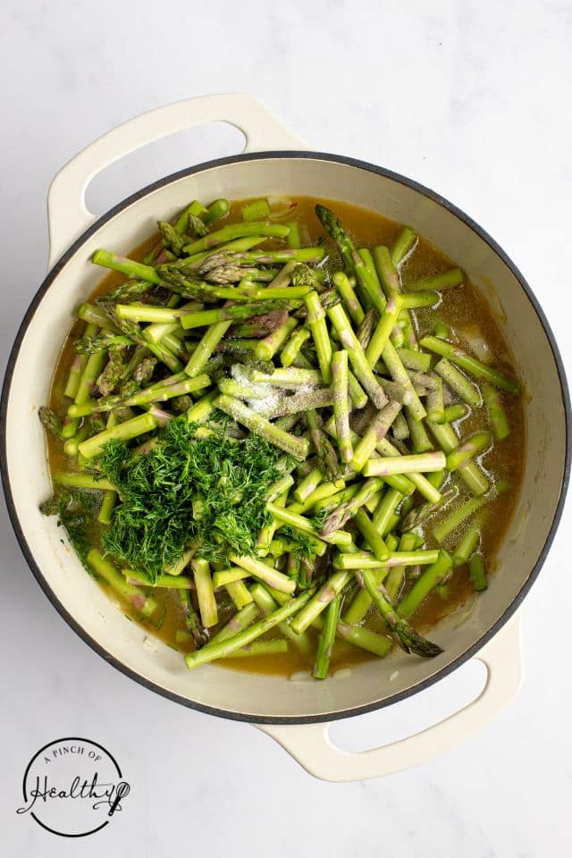 ingredients for asparagus soup in a Dutch Oven shot from overhead