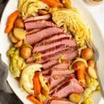 corned beef, cabbage, carrots, and potatoes on a white platter