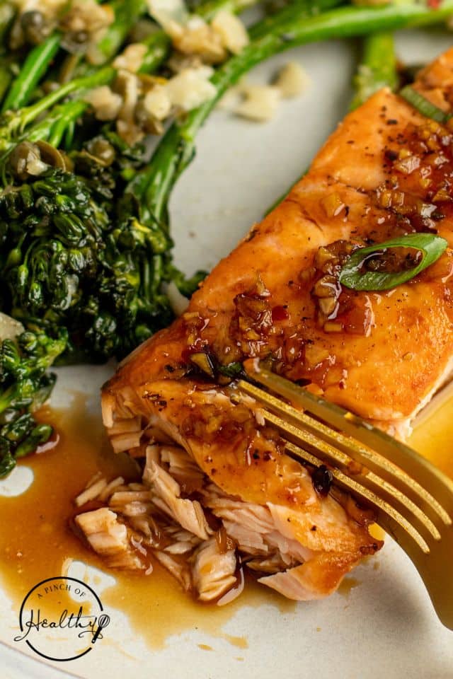 salmon with honey glazed on a white plate with broccolini