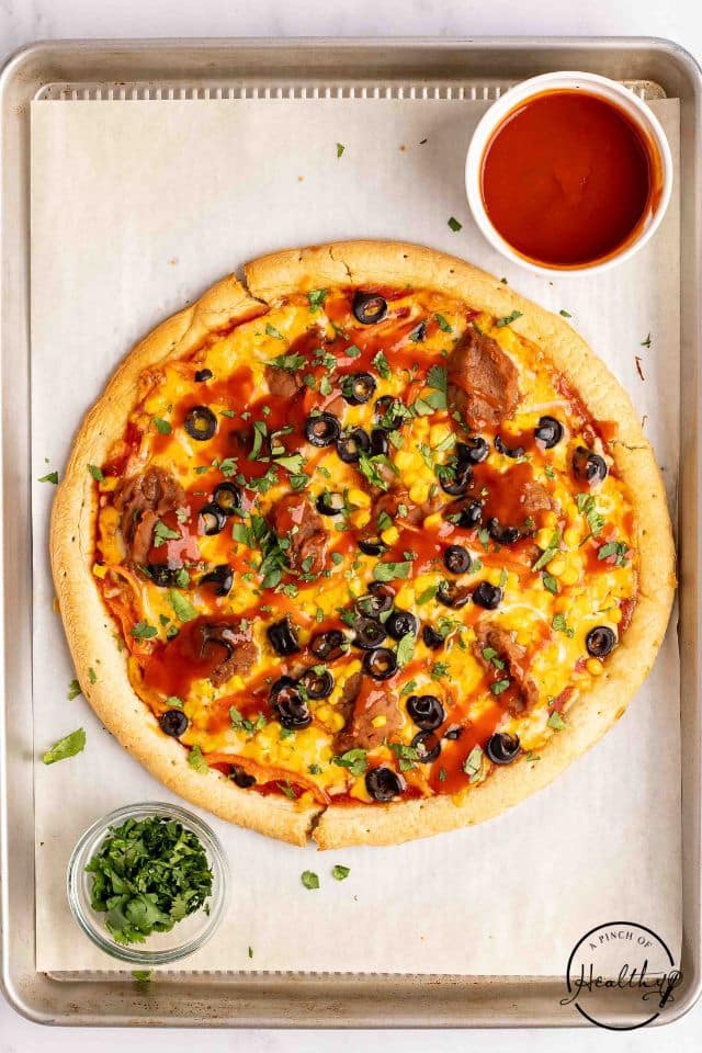 mexican pizza finished and drizzled with taco sauce