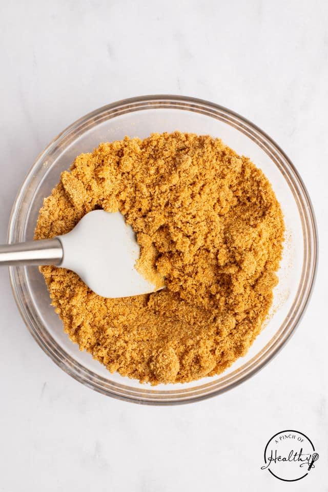 Graham cracker crumbs in a glass bowl shot from overhead