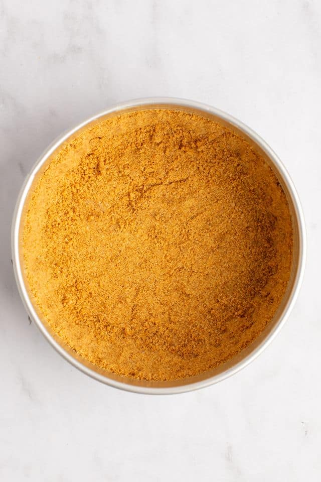Graham cracker crumbs pressed into a pan to form the crust
