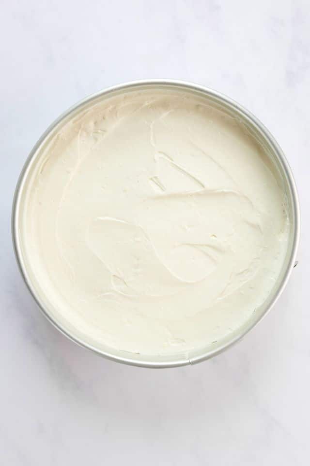 No bake cheesecake in a springform pan before being refrigerated.