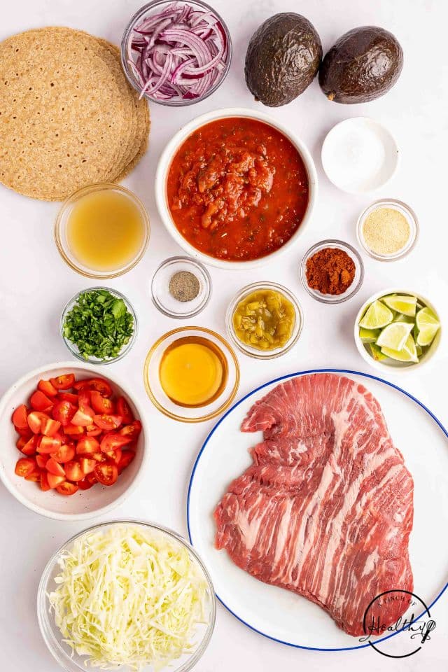 Ingredients for brisket tacos on a white background in separate containers.