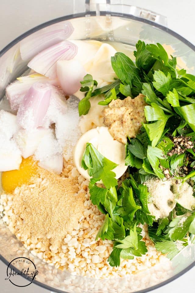 Ingredients for salmon cakes in a food processor before mixing.