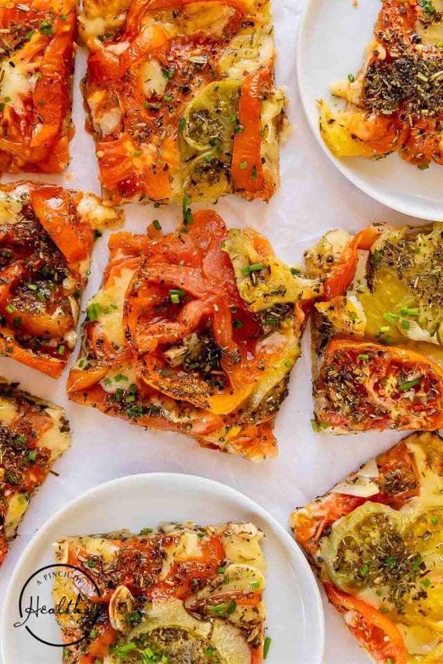 Finished tomato tart on a white background.