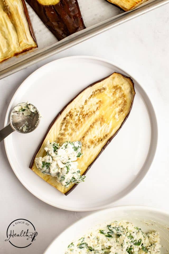 One slice of roasted eggplant with some of the spinach mixture on one end.