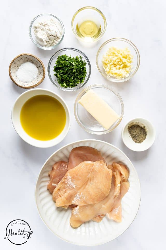 Ingredients for garlic butter chicken in separate containers on a white background.
