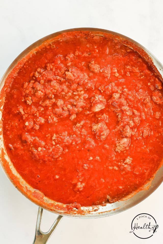 Meat sauce for lasagna in a large skillet.