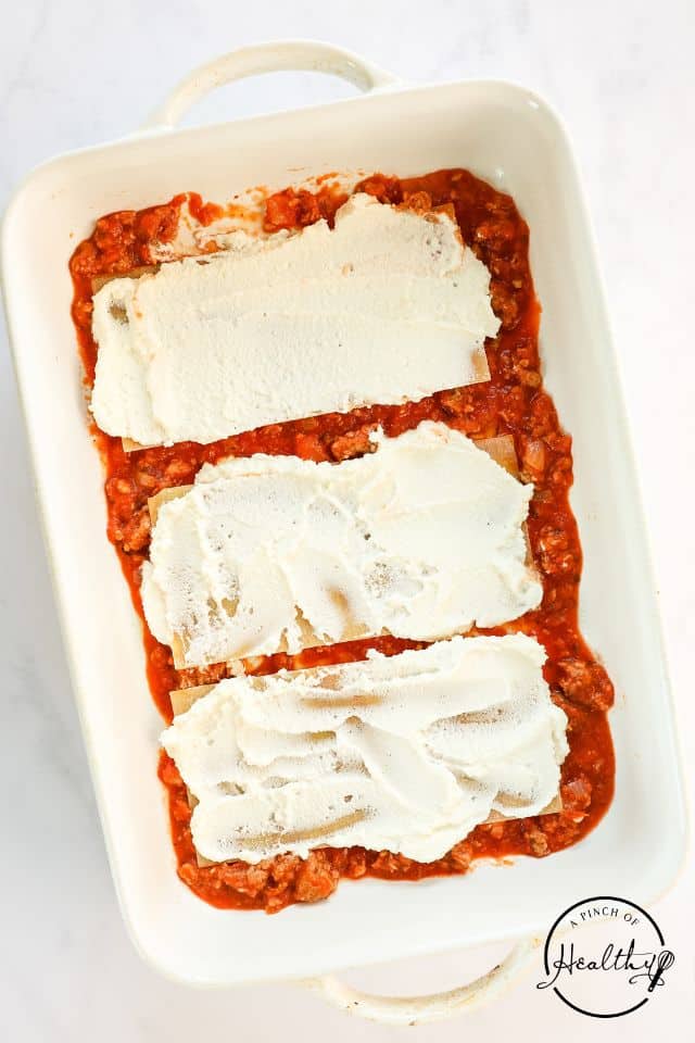 Pasta and cheese in a large baking dish.