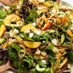 Peach Salad in a large bowl with a wooden spoon inside.