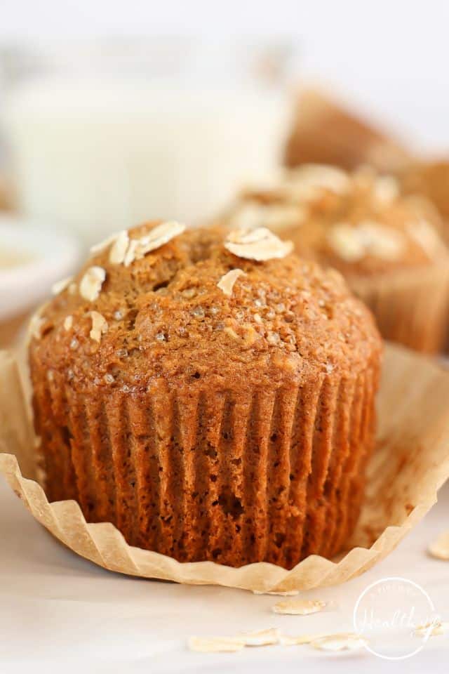 Closeup of an applesauce muffin with part of the muffin lined removed to show the texture.