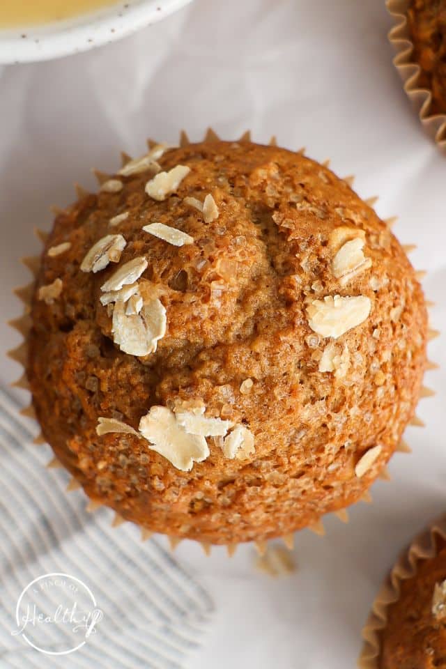 Applesauce muffins close up showing the texture and oats on top.