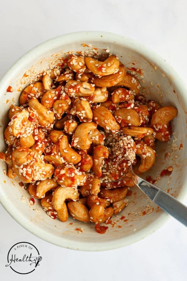 Cashews after being mixed with the seasoning blend before getting toasted.