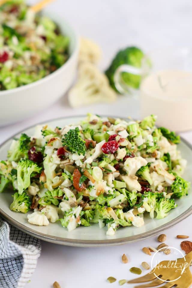 Broccoli cauliflower salad on a gray plate.