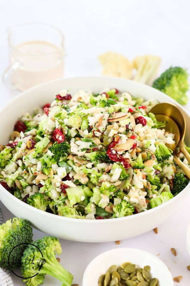 Broccoli cauliflower salad in a large white bowl.