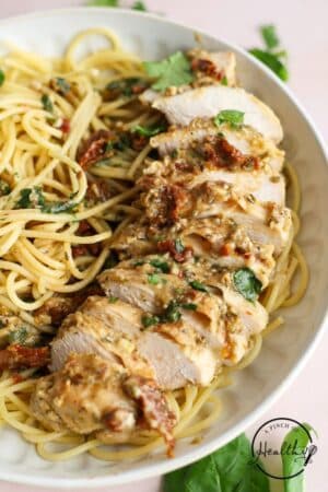 Marry Me Chicken with pasta in a large white bowl.