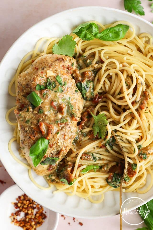 Marry Me Chicken with pasta garnished with parsley.