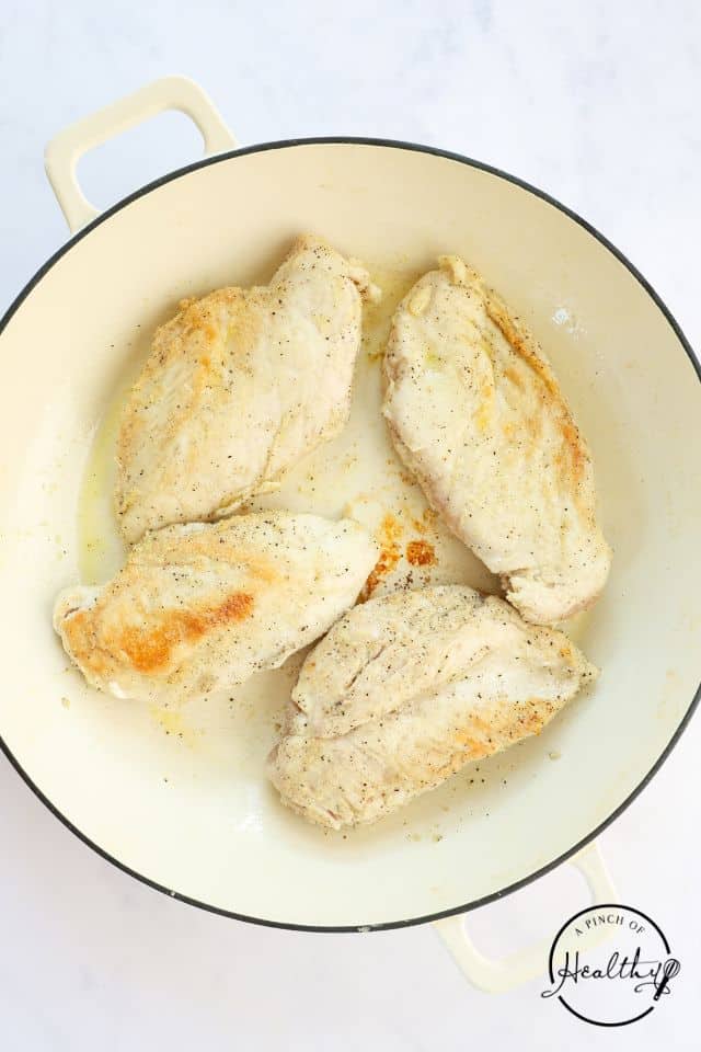 Cooked chicken in a large Dutch Oven.