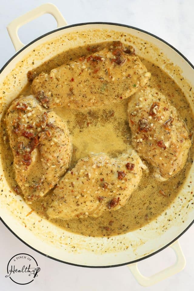 Marry Me Chicken in the pan cooking with sauce on top.