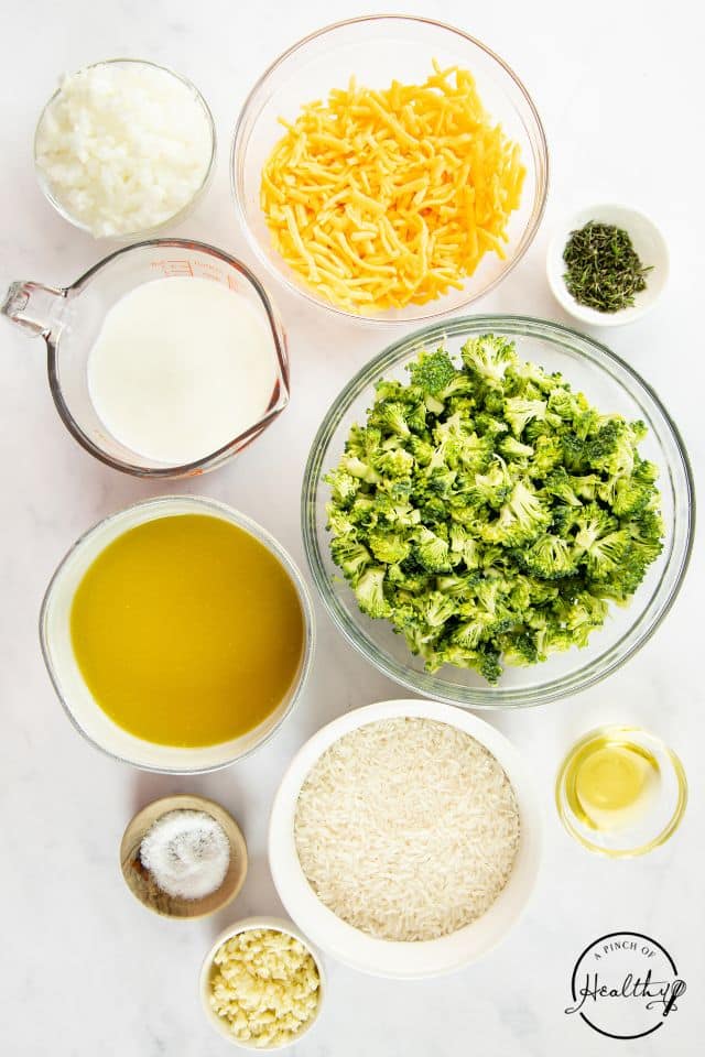 Ingredients for broccoli rice casserole on a white background in separate containers.