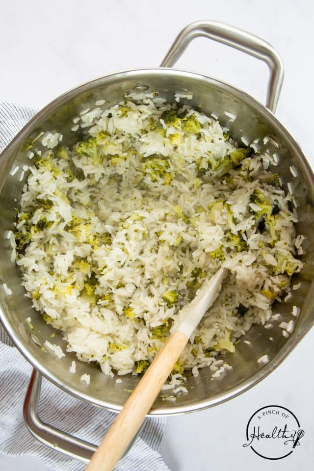 Rice and broccoli in a pan after being cooked for broccoli rice casserole.